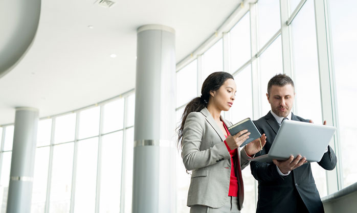 Image showing a man explaining something to a woman using his laptop