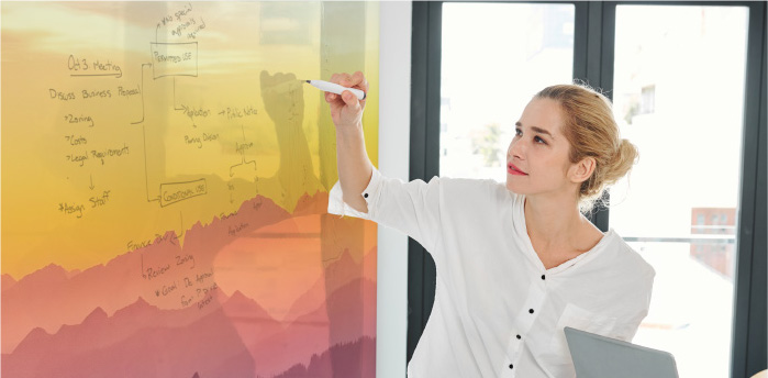 Stock image of a girl writing on a writable surface
